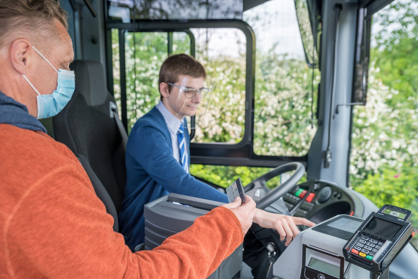 Bargeldloses Bezahlen in den Regionalbussen ist nun möglich. Mann bezahlt mit Kreditkarte beim Einsteigen.